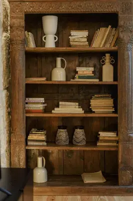 a wooden book shelf with vases and books at Líbere Porto Laranjais in Porto