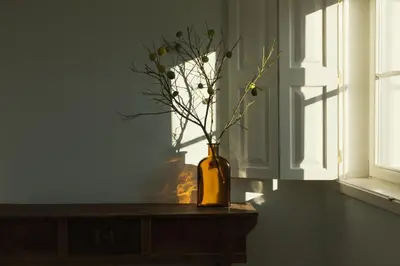 a vase with flowers in it sitting on a table at Líbere Porto Laranjais in Porto