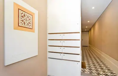 a hallway with white drawers and a painting on the wall at Oporto Blue Almada - Deluxe Citycenter Flat in Porto