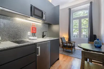 a kitchen with a counter top and a table at Oporto Sao Lazaro Apartment in Porto