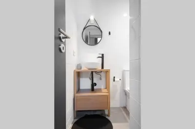 a bathroom with a sink and a mirror at Oporto Sao Lazaro Apartment in Porto