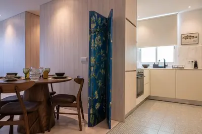 a kitchen and dining room with a table in a room at The Cathedral's Terrace in Porto