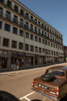 a brown car parked in front of a building at The Cathedral's Terrace in Porto
