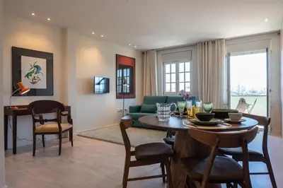 a living room with a table and a green couch at The Cathedral's Terrace in Porto
