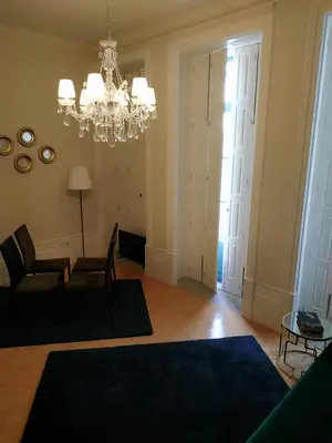 a living room with a couch and a chandelier at ML Apartments Almada Living in Porto