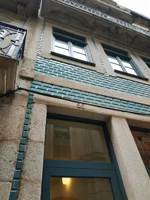 a building with two windows and a blue door at ML Apartments Almada Living in Porto