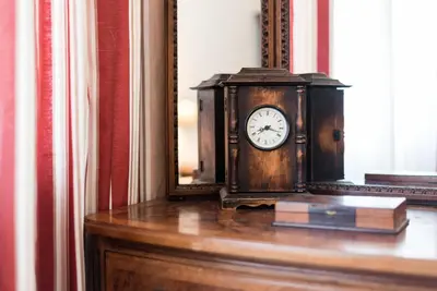 a clock sitting on a table in front of a mirror at GuestReady - Urban escape in Porto in Porto