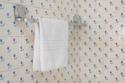 a towel hanging on a wall with blue and white tiles at GuestReady - Urban escape in Porto in Porto