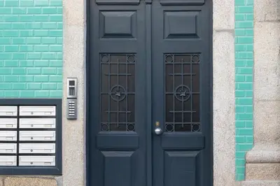 a pair of black doors on the side of a building at HM – Oporto Downtown Swimming Pool Apartment in Porto