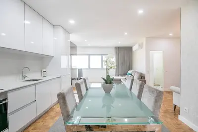 a kitchen and dining room with a glass table at Casa D'Ouro Apartment by Oporto Soul in Porto