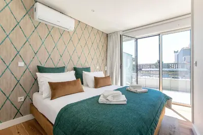 a bedroom with a bed with towels on it at Luminous Premium Loft w/AC & Terrace by LovelyStay in Porto