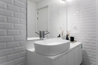 a white bathroom with a sink and a mirror at Luminous Premium Loft w/AC & Terrace by LovelyStay in Porto