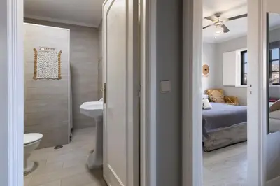 a bathroom with a bed and a sink and a toilet at MyRiverPlace N 5 River View Porto apartments in Vila Nova de Gaia