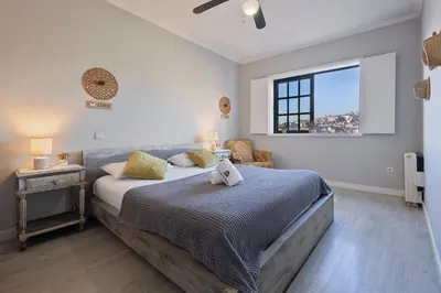 a bedroom with a large bed and a window at MyRiverPlace N 5 River View Porto apartments in Vila Nova de Gaia