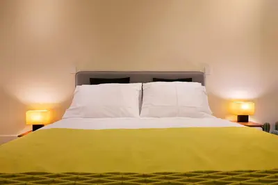 a bedroom with a bed with two lamps on either side at Ribeira Trendy Flat in Medieval Mercadores Street in Porto