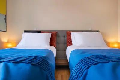 two beds sitting next to each other in a room at Ribeira Trendy Flat in Medieval Mercadores Street in Porto