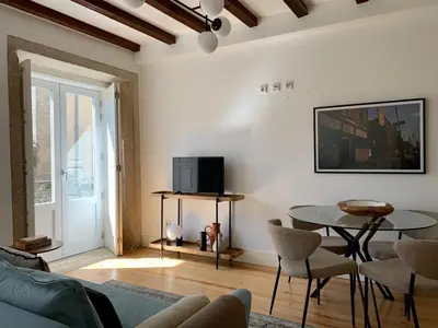 a living room with a table and a tv at Oporto Chic&Cozy - São Bento da Vitória in Porto