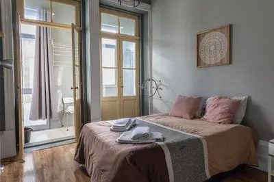 a bedroom with a bed and a window at Rustic Apartment in Poveiros in Porto