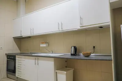 a kitchen with a sink and a microwave at Rustic Apartment in Poveiros in Porto