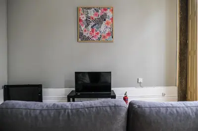 a living room with two couches and a flat screen tv at Rustic Apartment in Poveiros in Porto