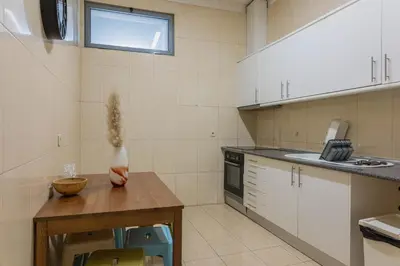 a kitchen with a table and a vase on a table at Rustic Apartment in Poveiros in Porto