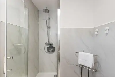 a bathroom with a shower with a glass door at GuestReady - Tigerlily in Porto