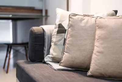 a couch with pillows and a tie on it at GuestReady - Subzero Design in Porto
