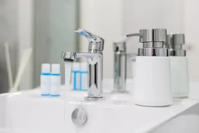 a bathroom sink with a faucet and toothbrushes at GuestReady - Subzero Design in Porto