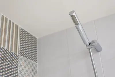 a shower head in a bathroom with a building at GuestReady - RiverWood Mezz in Porto