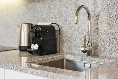 a kitchen counter with a sink and aounter at GuestReady - RiverWood Mezz in Porto