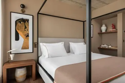 a bedroom with a large bed and a mirror at Exe Essenzia Porto in Porto