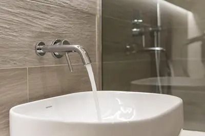 a white sink with a water faucet in a bathroom at GuestReady - Lazaro Studio in Porto