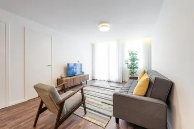 a living room with a couch and a chair at GuestReady - Square Painted Ceuta in Porto