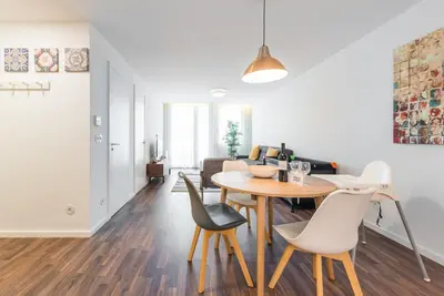a dining room and living room with a table and chairs at GuestReady - Square Painted Ceuta in Porto