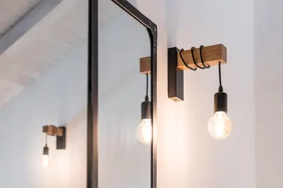 a group of lights hanging on a wall at GuestReady - Ladder Mezz in Porto