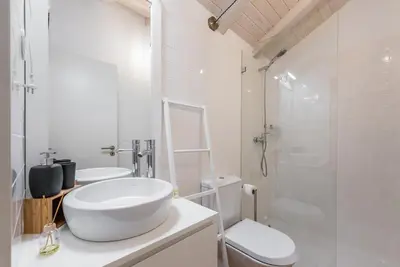 a bathroom with a sink and a toilet and a shower at GuestReady - Ladder Mezz in Porto
