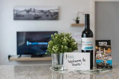 a bottle of wine sitting on a counter with a plant at GuestReady - Porto Fantastic View in Vila Nova de Gaia
