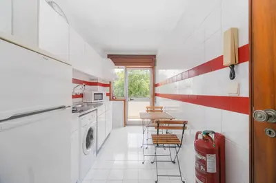 a kitchen with a washing machine and a washer and dryer at Nomad's Easy Stay - 1BED Sunrise Cedofeita in Porto