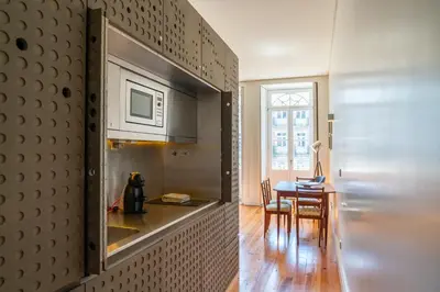 a kitchen with a stainless steel refrigerator and a table at Beauty Porto in Porto