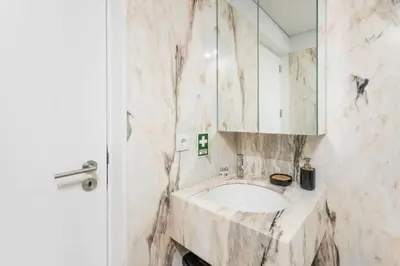 a marble bathroom with a sink and a mirror at Bright Studio in the Heart of Porto by Great&Cosy in Porto