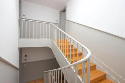 a staircase with white railings and wood floors at CASA JOY Cathedral apartment in Porto