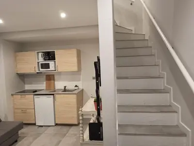 a staircase leading up to a kitchen with a microwave at ORM- Fontainhas 01 & 02 Apartments in Porto