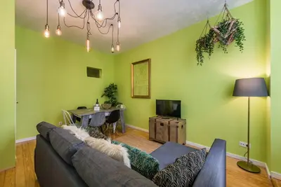 a living room with a couch and a table at GuestReady - Miragaia Green in Porto