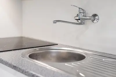 a stainless steel sink with a faucet on a counter at GuestReady - Miragaia Historical Sight in Porto