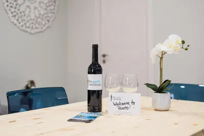 a bottle of wine sitting on a table with two glasses at GuestReady - Miragaia Historical Sight in Porto