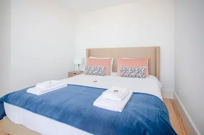 a bedroom with a large bed with towels on it at Liiiving in Porto - City View Apartments in Porto