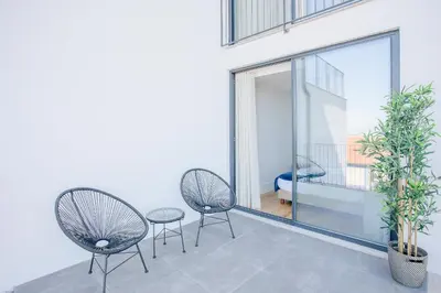 two chairs and a table on a balcony at Liiiving in Porto - City View Apartments in Porto