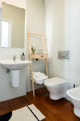 a bathroom with a sink and a toilet and a mirror at Impar luxury residence in Porto