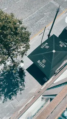 a green umbrella sitting on top of a building at Impar luxury residence in Porto