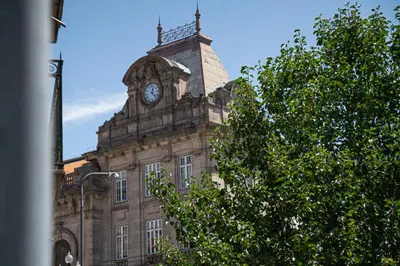 a building with a clock tower on top of it at Impar luxury residence in Porto